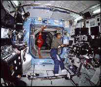 STS- 105, inside the Destiny Lab, Astronaut Jim Voss at work.